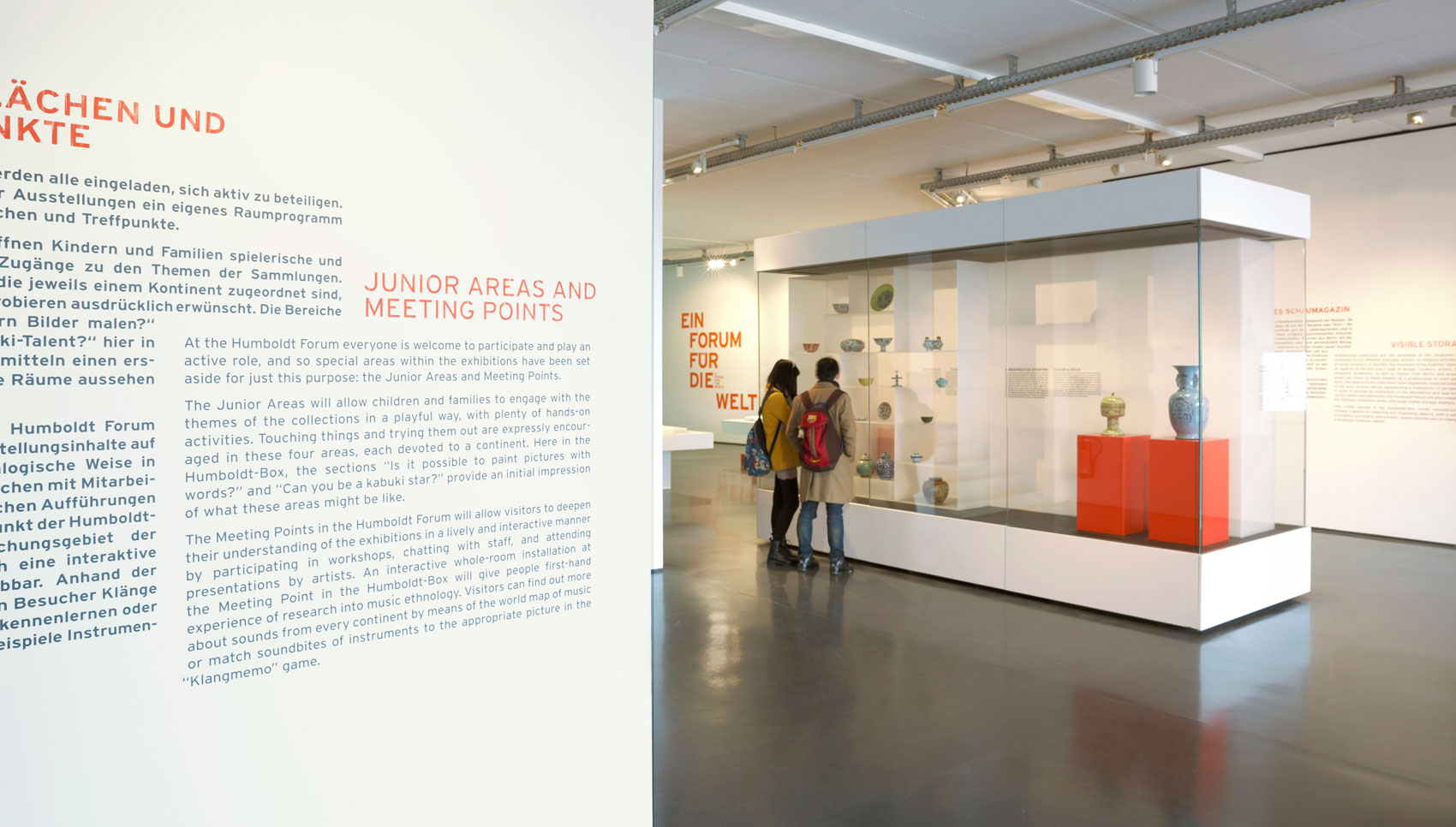 Besucher stehen vor großer Schrankvitrine mit unterschiedlichen Porzellan Exponaten