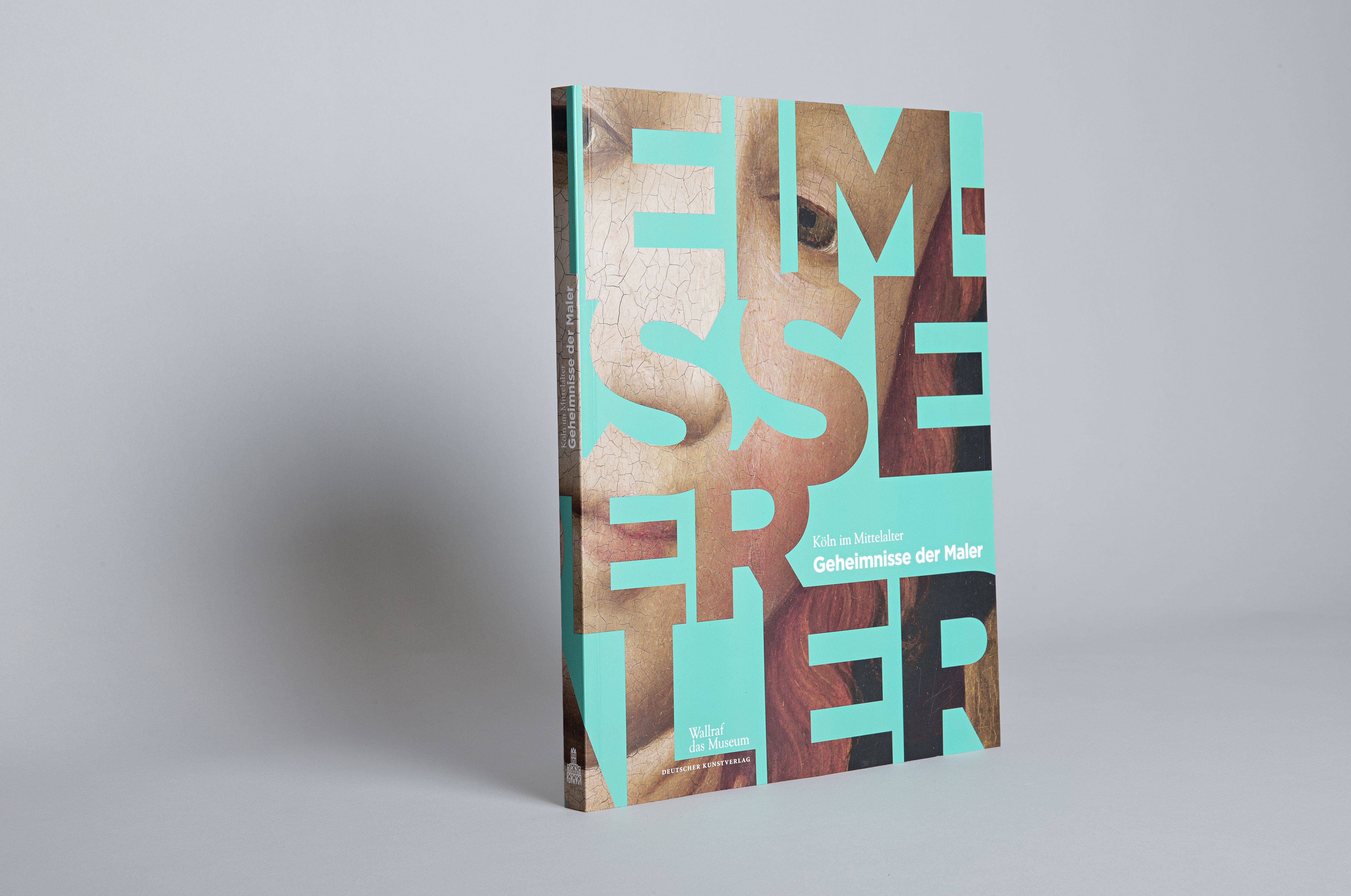Foto eines stehenden Katalogs zur Ausstellung "Köln im Mittelalter – Geheimnisse der Maler"