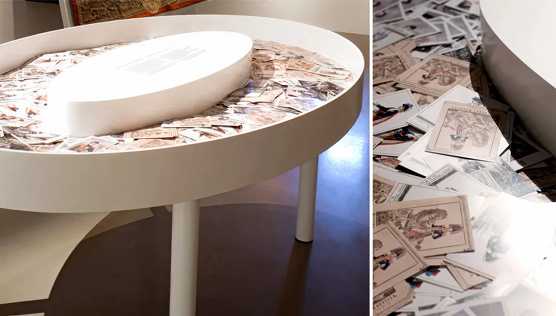 Weißes, ovales Möbel, in dem Postkarten mit verschiedenen illustrierten Motiven liegen.