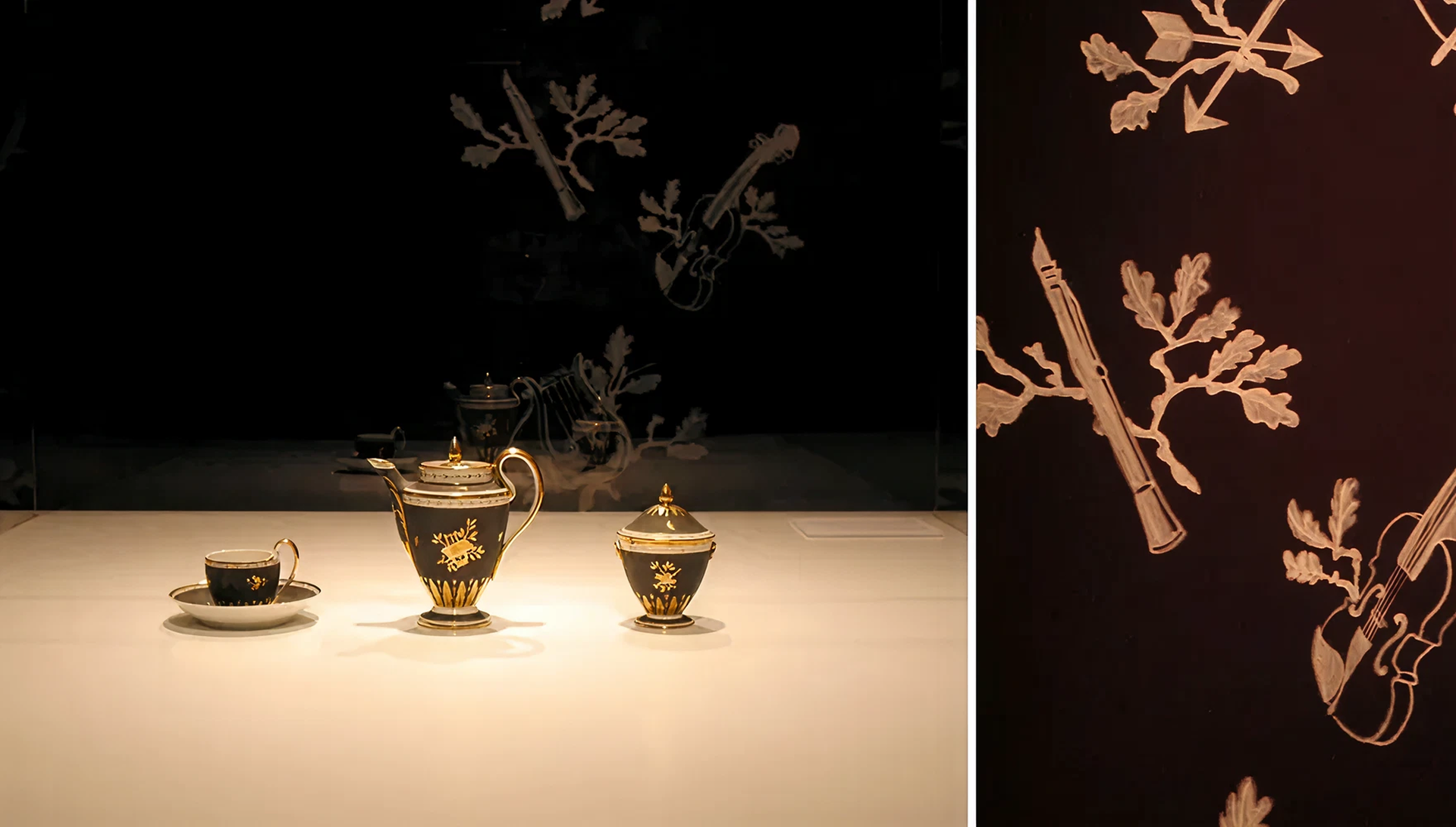 Weißes Porzellan mit großflächiger schwarzer Gestaltung auf der goldene Verzierungen zu sehen sind