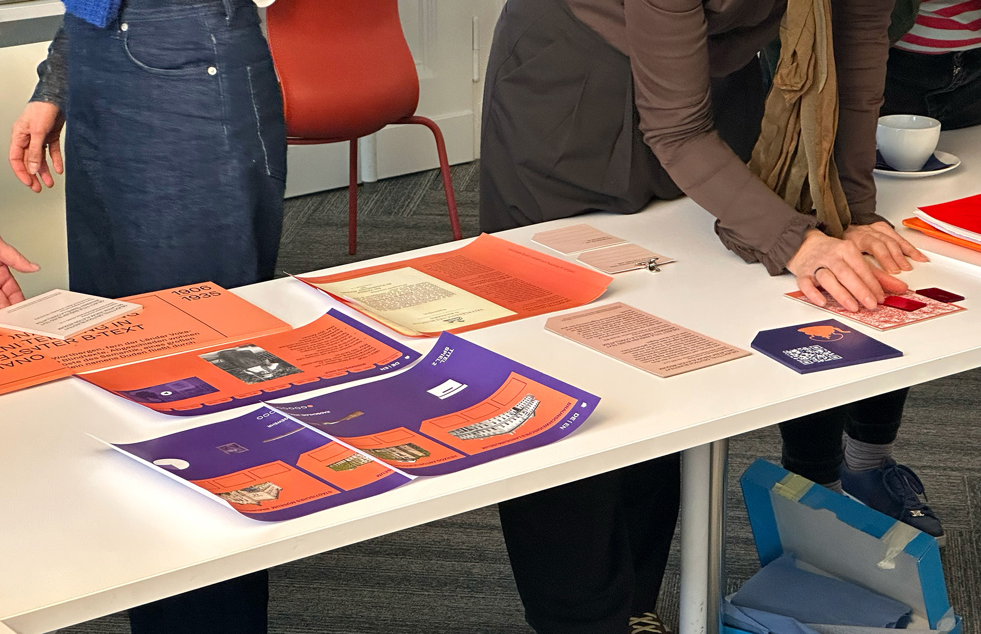 Das Museumsteam betrachtet die Auslage der verschiedenen Muster